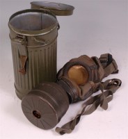 Lot 277 - A WW II German gas mask stamped FE42, in...