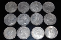 Lot 54 - British Colonial, 12 silver one rupee coins to...