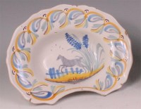 Lot 442 - A 19th century French faience barbers bowl,...