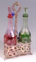 Lot 456 - A late 19th century silver plated three-bottle...