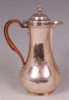 Lot 488 - A George II silver hot water pot, having...