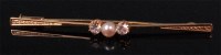 Lot 564 - A ladies 14ct gold pearl and diamond set bar...