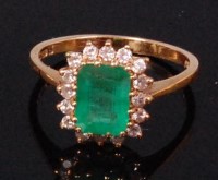 Lot 581 - An 18ct gold emerald and diamond cluster ring,...