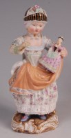 Lot 323 - A Meissen porcelain figure of a girl with her...