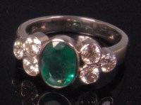 Lot 488 - An 18ct white gold emerald and diamond set...