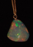 Lot 521 - A heavy polished opal pendant, on 14ct gold...