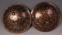 Lot 604 - A pair of Indo-Persian metal dhal shields, of...