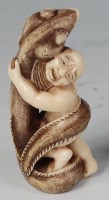 Lot 663 - A Japanese Meiji period carved ivory netsuke,...