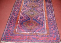 Lot 847 - A Persian woollen blue ground rug, the central...