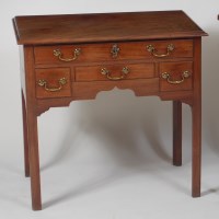 Lot 850 - A George III mahogany lowboy, having a single...