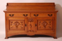 Lot 250 - An Art Nouveau oak ledgeback sideboard by...