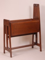 Lot 251 - An Arts & Crafts panelled oak baby's rocking...