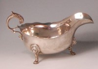 Lot 824 - *A George V silver sauceboat, double crested...