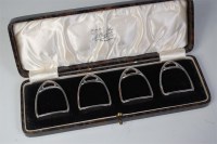 Lot 866 - A cased set of four silver napkin rings, in...