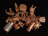Lot 896 - A 9ct gold curblink charm bracelet, with...