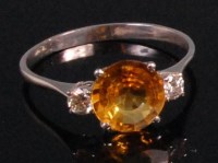 Lot 902 - A contemporary 18ct white gold yellow sapphire...