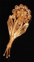 Lot 909 - An African yellow metal filigree worked brooch,...