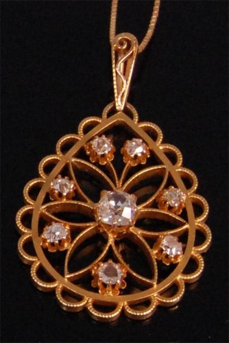 Lot 925 - A yellow metal diamond set openwork pendant,...