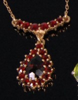 Lot 930 - A yellow metal garnet set pendant on neckchain,...