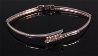 Lot 935 - A contemporary 9ct white gold hinged bracelet,...
