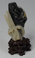 Lot 1108 - A Chinese celadon and black jade carving,...