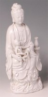 Lot 1126 - A Chinese blanc-de-chine figure of Guanyin, in...