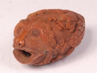 Lot 1063 - An 18th century finely carved coquilla nut, in...