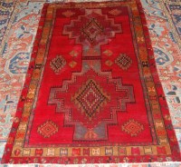 Lot 1269 - A Persian woollen rug, the red ground...