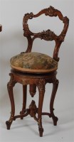 Lot 1331 - A Victorian walnut music seat, in the Rococo...