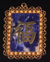 Lot 567 - A Chinese yellow metal lapis lazuli set...