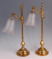 Lot 599 - A pair of early 20th century brass desklamps,...