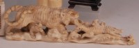 Lot 658 - A Japanese Meiji period carved ivory group,...