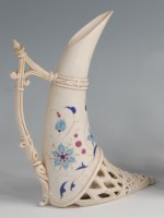 Lot 28 - A Zsolnay Pecs tusk vase, of stylised tapering...