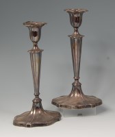 Lot 565 - A pair of Edwardian silver table candlesticks,...