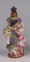 Lot 477 - A German porcelain scent bottle, modelled as...
