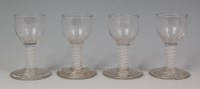 Lot 520 - A set of four 18th century firing glasses,...