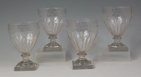 Lot 530 - A set of four Regency engraved glass rummers,...