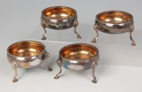 Lot 594 - A set of four George III silver table salts,...