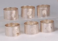 Lot 632 - A set of six silver napkin rings, each with...