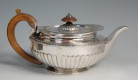 Lot 638 - A late Georgian silver teapot, of half reeded...