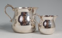 Lot 655 - A modern silver milk jug and matching smaller...