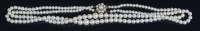 Lot 696 - A graduated cultured pearl double string...