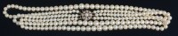 Lot 697 - A graduated cultured pearl triple string...