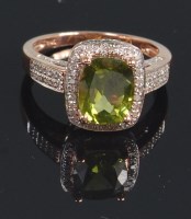 Lot 705 - A 14ct rose gold green peridot and diamond set...