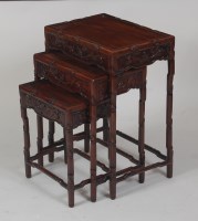 Lot 771 - A Chinese carved 'rosewood' nest of three...