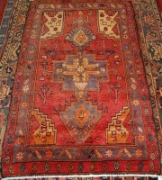 Lot 921 - A Persian woollen rug, having a poled field on...