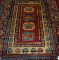 Lot 922 - A Persian woollen Kazak rug, having an...