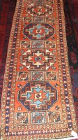 Lot 931 - A Kurdish woollen hall runner, the red ground...