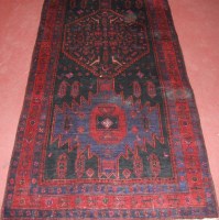 Lot 932 - A Persian woollen rug, the poled blue ground...