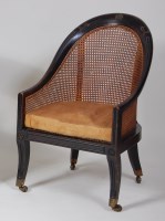 Lot 952 - A 19th century ebonised mahogany Bergere tub...